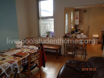 Living/dining room showing the kitchen at the end